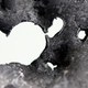 Illustration for article titled An Aluminum Plate After a 6,700 mph Collision With a Grain of Sand